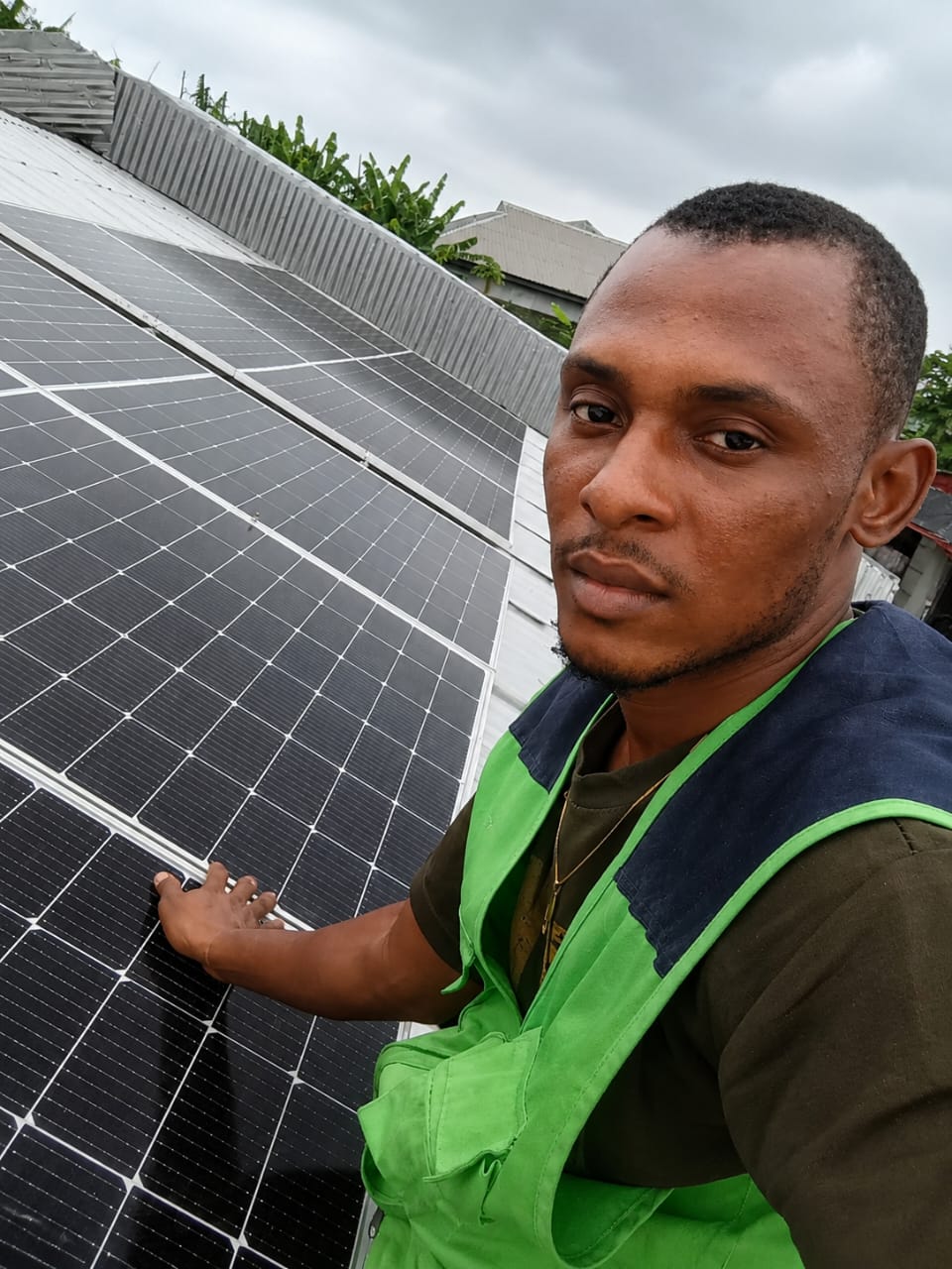 Promise Abang inspecting a solar install